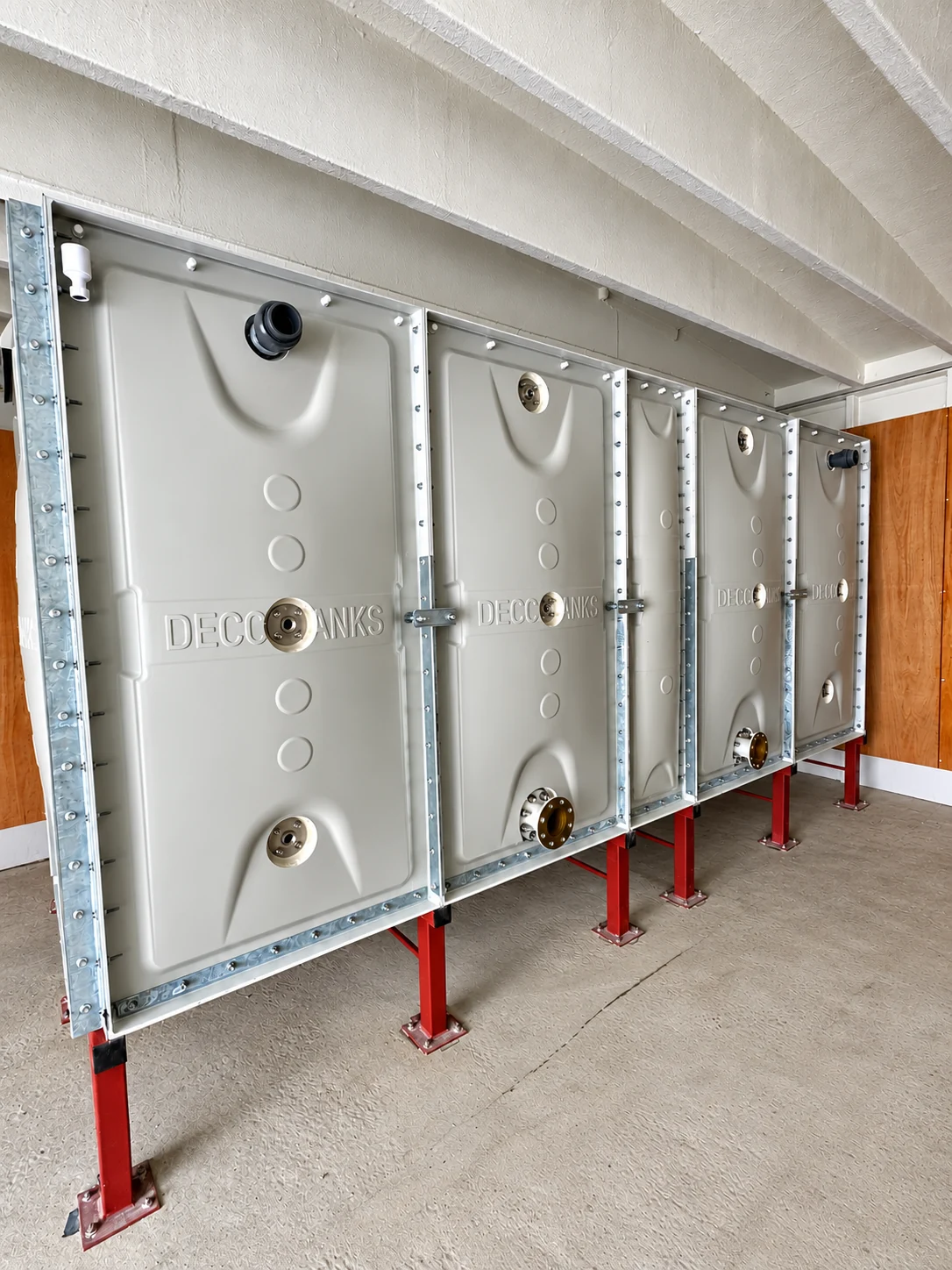 EFB sectional water tank on red steel supports in a plant room